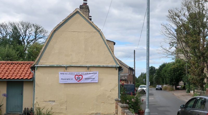 Image of house with a 20's Plenty Banner displayed on the side of the building