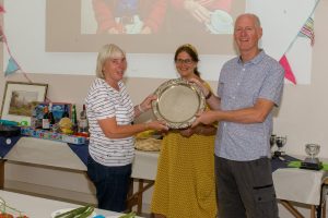 Kathy receives her award from Rosie and Paul