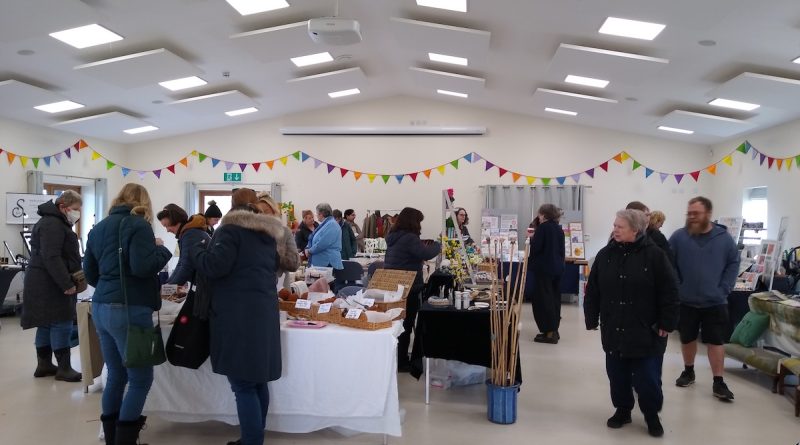 Image of Farmers' Market stalls and shoppers in the Memorial Hall, Great Wilbraham