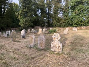 Gravestones clearly visible now that the wild meadow grasses have been cut