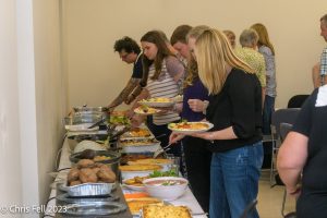 People helping themselves to the buffet