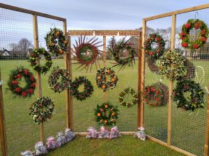 Display of festive wreaths for sale