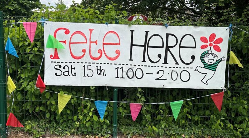Fete Here banner and bunting hanging on the fence outside the school